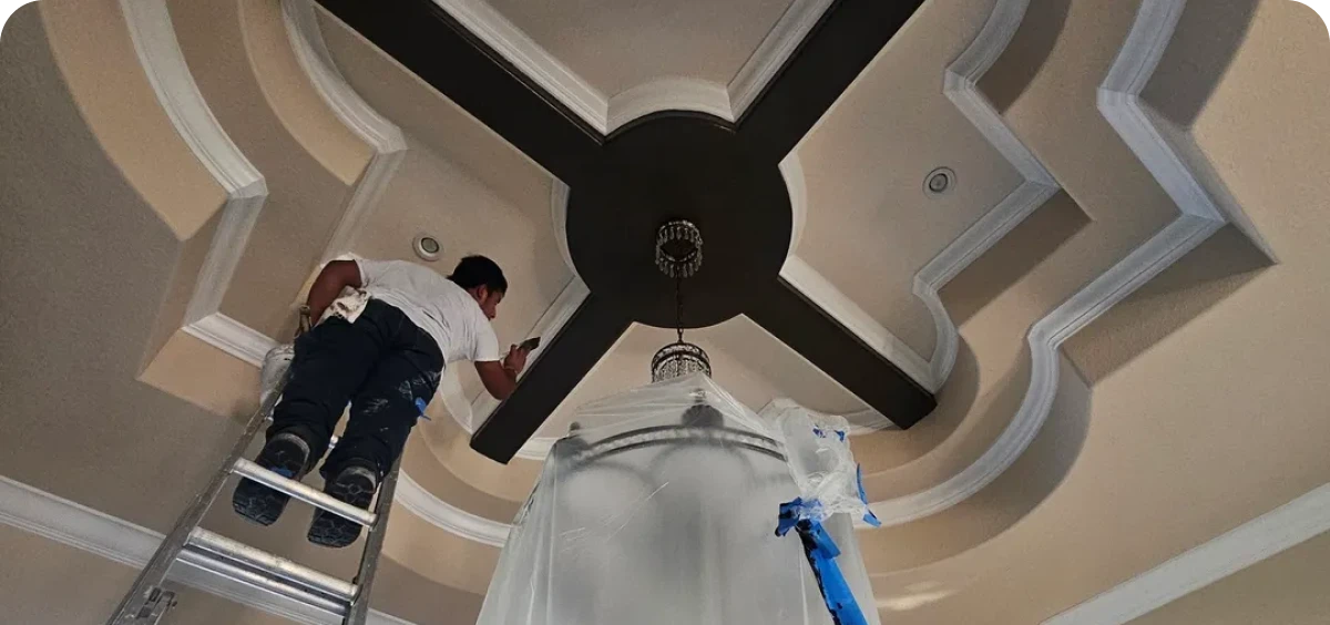 Man on ladder near ceiling light